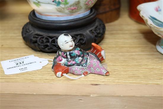 Two Chinese famille rose dishes, a figure of a boy, a porcelain brush pot and a bamboo brush pot tallest 28cm